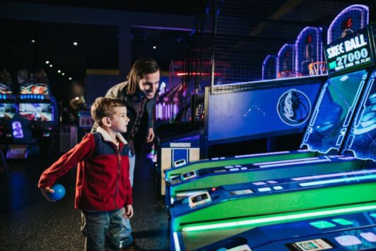 Kids play arcade games at Main Event.