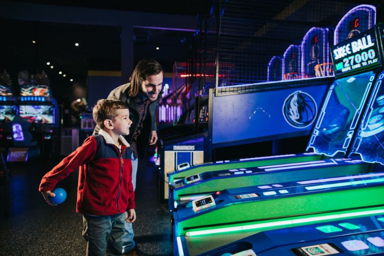 Kids play arcade games at Main Event.