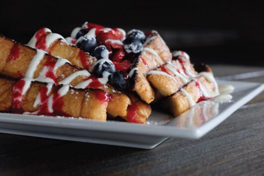 Rooster in downtown St. Louis serves French toast piled with fresh fruit.