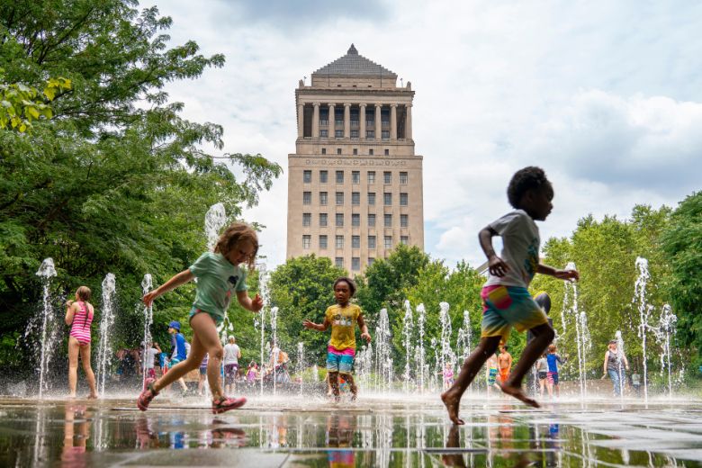 Kids play in the water features at Citygarden.